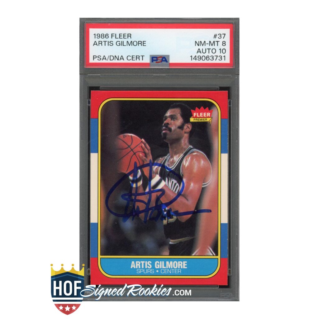 Autographed 1986 Fleer Artis Gilmore basketball card in a PSA/DNA holder with signed blue ink across the front panel.